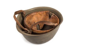 Old and used metal army helmet on a white