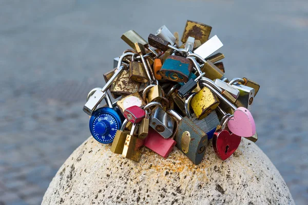 Love locks on the concrete post, heart shape.