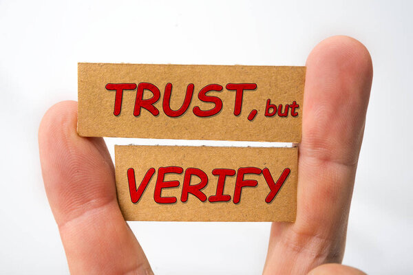 Trust, but verify sign on a white