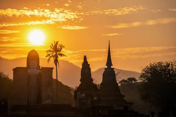 Amazing sunrise and Buddha statue in Sukhothai, Thailand