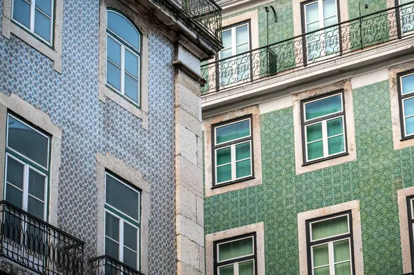 Historic buildings covered in blue and green azulejos in Lisbon, Portugal