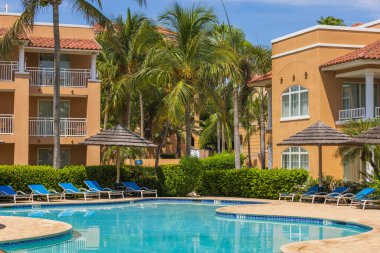 Gorgeous view of hotel's recreation area with outdoor pool, sun loungers and parasols. Aruba. Oranjestad. 01.17.2023.