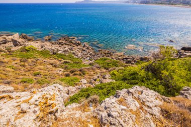 Beautiful view of rocky coast against background of turquoise water in Mediterranean sea. Greece.