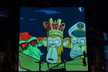 Close-up view of colorful frame of mm's Kingship advertisement film on huge outdoor led display board in darkness. New York. USA. 09.22.2022.