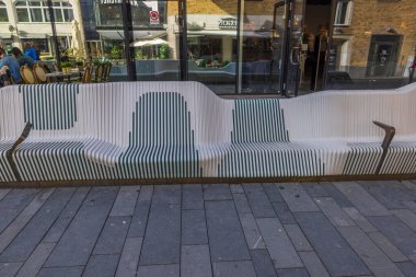 Close-up view of modern design bank along shop windows. Downtown Uppsala, Sweden, Europe. 05.14.2022.