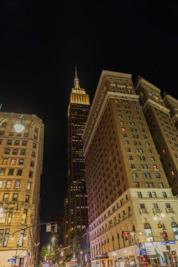 Beautiful night view of Empire State Building between two buildings. New York, Manhattan, USA. 09.22.2022.