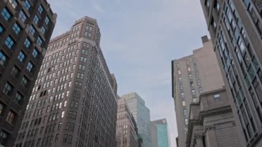 Gorgeous view of tops of Manhattan's skyscrapers on blue sky background. New York, USA. 09.21.2022.