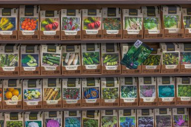 Close-up view of stand with  colorful bags of various seeds. Gardening concept. Sweden. Uppsala. 02.15.2023.