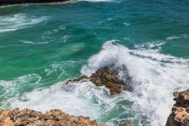 Gorgeous view of big turquoise waves of Atlantic ocean crashing on rocks of island of Aruba.