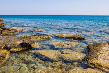 Gorgeous view of rocky coast of Mediterranean Sea in summer day. Greece.