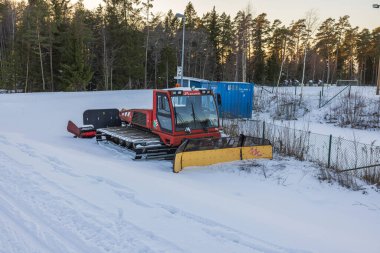 View of colorful machine for machine ski tracks laying. Sweden. Storvreta. 02.26.2023. 