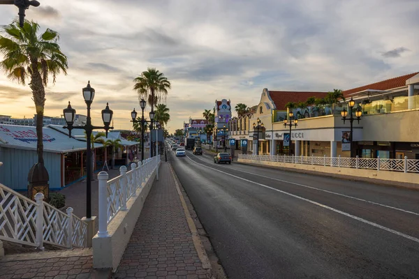 stock image View of main street in city of Oranjestad with passing cars on sunset. Aruba. Oranjestad. 10.28.2022.