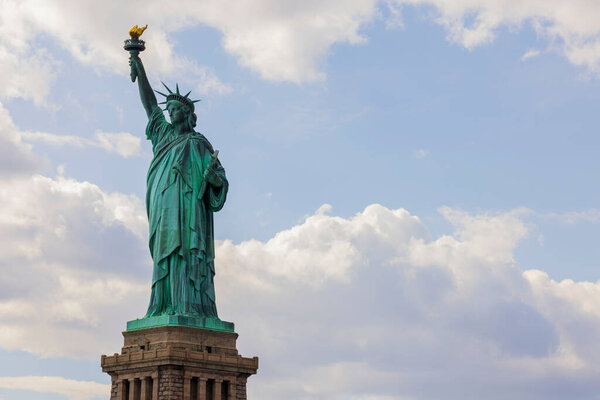Beautiful view of Statue of Liberty against backdrop of white clouds. New York. USA.