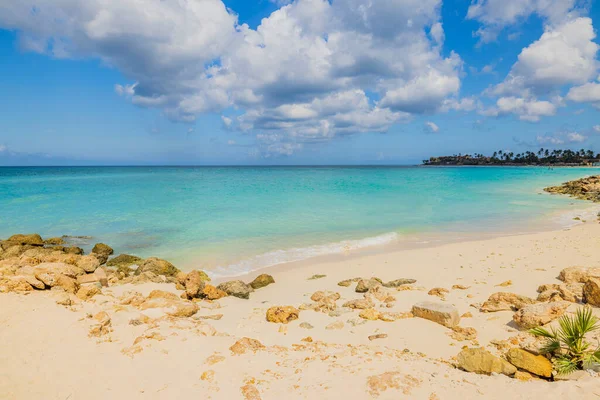 砂のビーチの美しい自然景観ターコイズブルーの水白い雲と青い空と大西洋の海の表面がマージされます アルバ — ストック写真