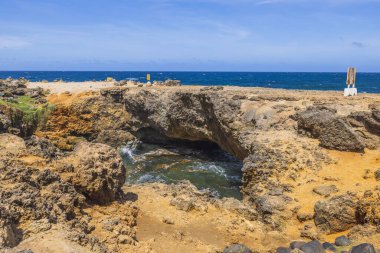 Güzel doğa manzarası. Aruba Adası 'nın Rocky doğu kıyısı. Karanlık okyanus suyu ve mavi gökyüzü arka planı.. 