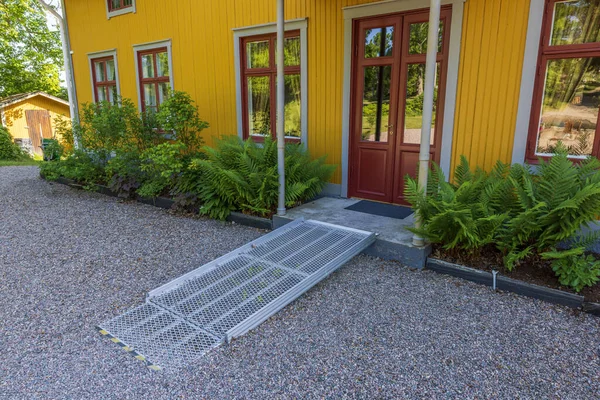 View of expanded metal wheelchair ramp infront of private house. Sweden.