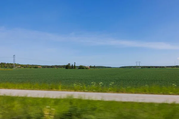 stock image Beautiful nature countryside landscape view. Green fields on blue sky with white clouds background. Sweden. Europe