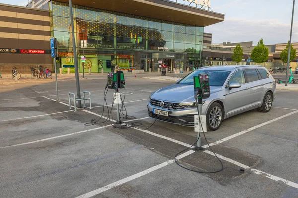 stock image View of connected charging cable to Volkswagen car from electric vehicle charging station. 