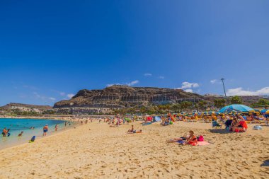 Beautiful view of people on Amadores Beach of Grand Canaria on hot summer sunny day. Gran Canary. Spain. 