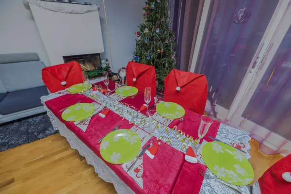 Beautiful view interior of room decoration and served table and decorated Christmas tree. Sweden.