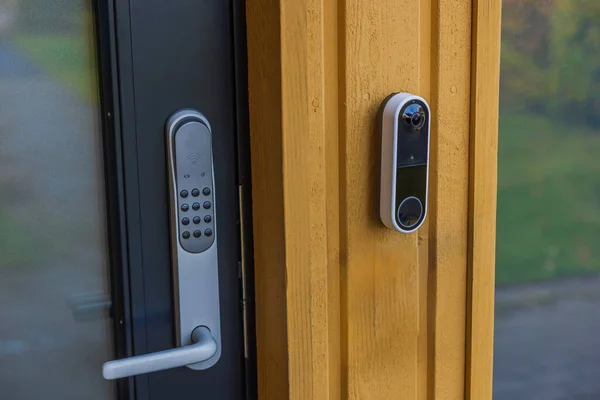 lose-up of high-tech video intercom system and electronic lock on entrance door of villa. Concept of home security and surveillance. Sweden.