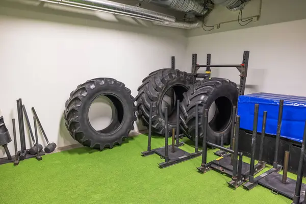 View of gym with roll-over tires for strongman training and various other sports equipment for active sports workout. Sweden.