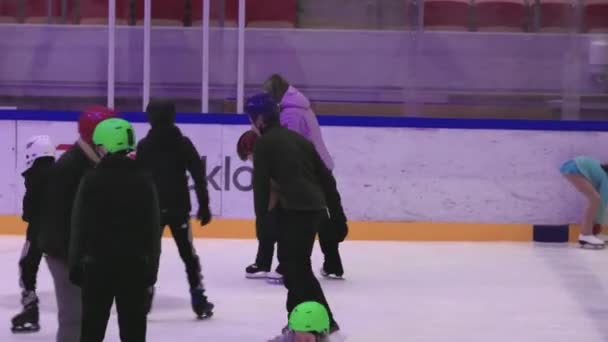 Yetişkinler Çocukların Buz Pateni Sahasında Ilk Adımlarını Atmalarına Yardım Ediyor — Stok video