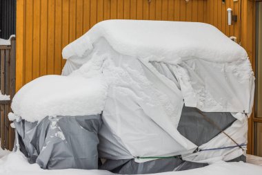 Detailed view of back section of villa featuring winter-stored outdoor furniture. Sweden. clipart