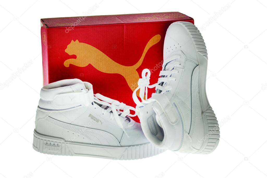 Close-up view of high-top white Puma sneakers with red box on white background.