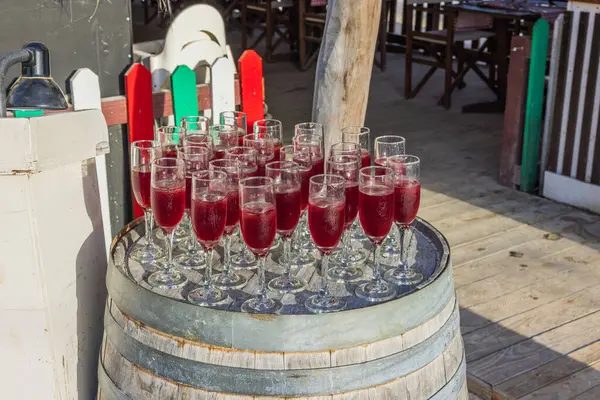 Welcoming setup of drinks on a barrel at the entrance of an Italian restaurant, invitingly arranged for guests. Curacao.