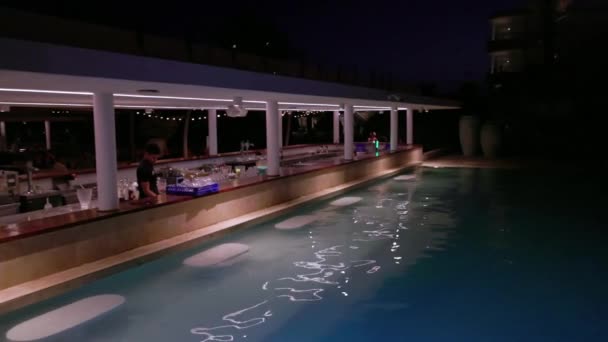 游客们喜欢深夜在酒店游泳池里游泳 并在酒吧点饮料 展示酒店活泼的氛围 — 图库视频影像
