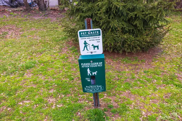 stock image Clean up after your pet with our waste bag dispenser. Keep the park clean for all! Paramus. USA. 