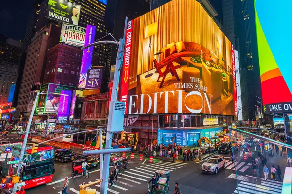 stock image Beautiful night view of Times Square with illuminated neon advertisements on the facades of skyscrapers, transportation and people walking along Broadway. New. USA. 