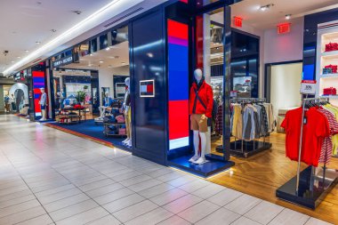 Close-up view of Macy's interior featuring the Tommy Hilfiger men's clothing section. New York. USA.  clipart