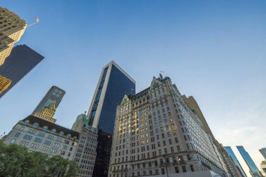 Beautiful view from the bottom to the top of Manhattan skyscrapers against the backdrop of the blue sky. USA. New York.