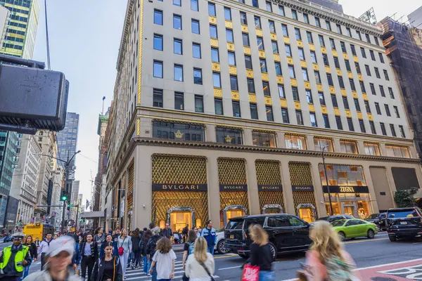 stock image Beautiful view of a bustling street scene on Fifth Avenue in New York City, featuring people walking and luxury shops like Bvlgari and Zegna on a sunny day. New York. USA. 