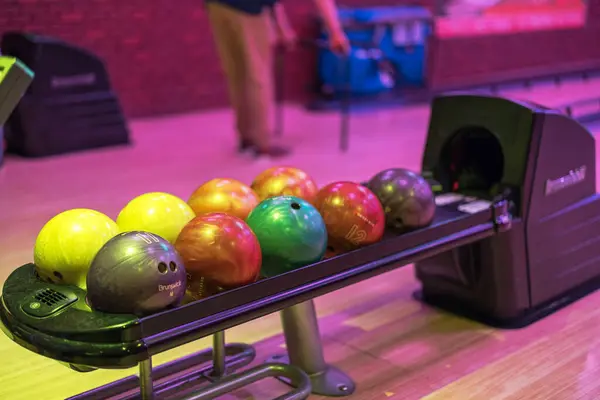 stock image Close up view of automatic ball return system in bowling alley, efficiently collecting and delivering balls back to players.