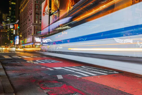 stock image Night view of Manhattan with light tracers from passing car headlights, creating blurred light trails and streaking effects. New York.