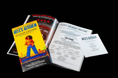 Close-up view of promotional brochure and materials for the musical 'Hell's Kitchen' isolated on black background. New York. USA. clipart