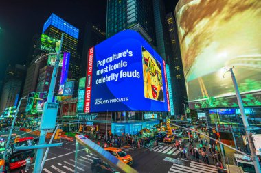 Geceleri Times Meydanı 'nda New York' ta Wondery Podcast reklamları da dahil olmak üzere büyük dijital reklam panoları yer alıyor. ABD.
