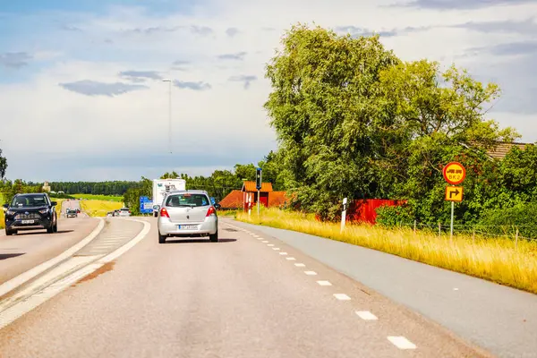 stock image Cars on rural road monitored by speed radar on roadside. 