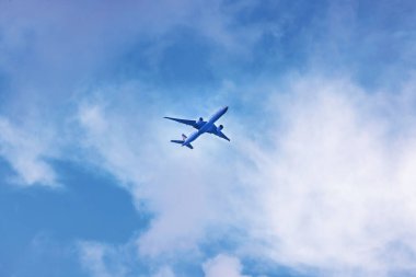 Airplane flying in the sky during landing approach in Miami. clipart