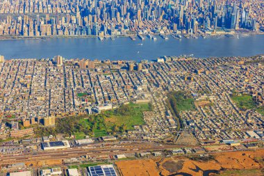 Aerial view of New York City skyline and urban residential area along Hudson River, with Manhattans skyscrapers and dense neighborhoods. USA. clipart