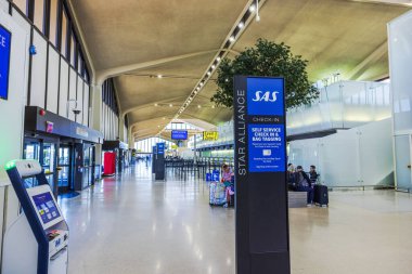 SAS self-service check-in area at Newark Liberty International Airport with modern architecture and clear signage. New Jersey, USA. clipart