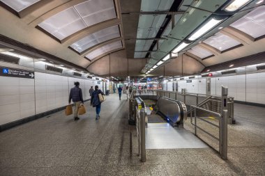 İçinde yürüyen merdivenler, yürüyen insanlar ve kemerli tavanların altında ulaşılabilir tabelalar olan modern metro istasyonu. - New York. ABD.