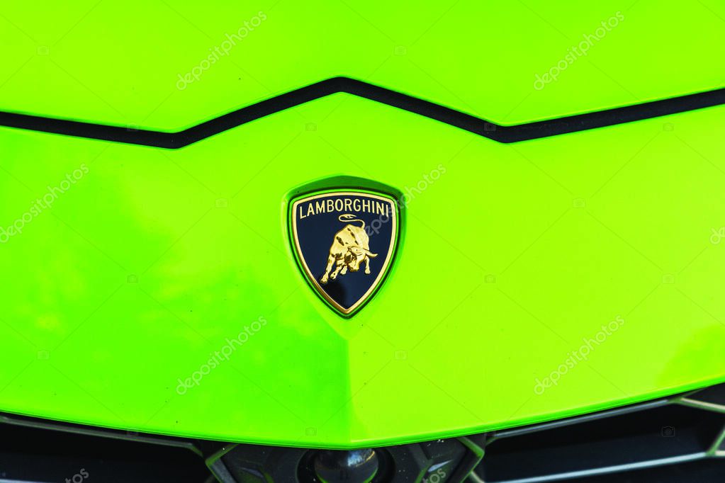 Close up view of Lamborghini badge on hood of green Lamborghini Urus parked on Ocean Drive in Miami Beach. Miami Beach. USA.