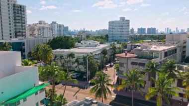 Miami Sahili 'nin güneşli manzarası. Palmiye ağaçları, oteller ve mavi gökyüzünün altındaki gökdelenler. Miami Plajı. ABD. 