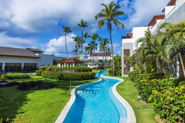 Dominik Cumhuriyeti 'nde Atlantik Okyanusu yakınlarında palmiye ağaçları ve tropikal bahçesi olan bir tatil havuzu. Punta Cana.