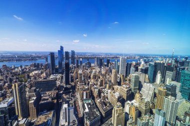 Aerial view of Manhattan with skyscrapers and Hudson River on background under clear blue sky. New York. USA.