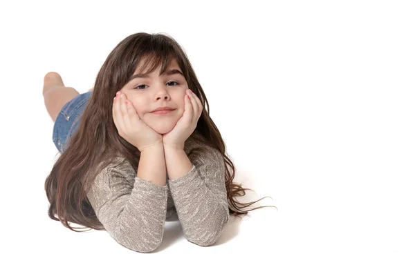 Happy Tanned Young Girl Lying Floor Looking Camera White Background — Stock Photo, Image
